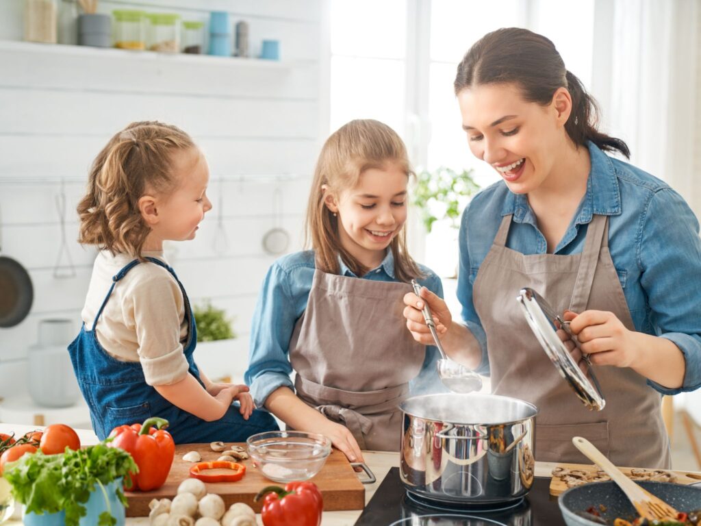 A family cooking beef in the kitchen